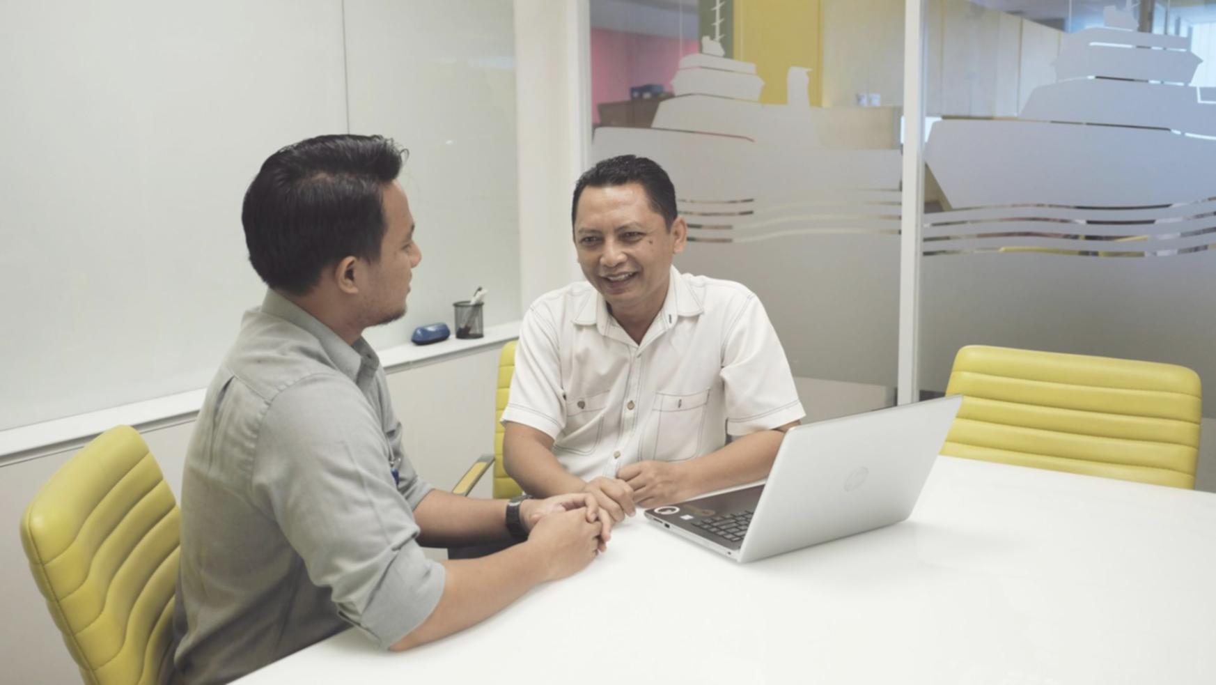 Professional business consultation showing financial planning documents and collaborative meeting environment